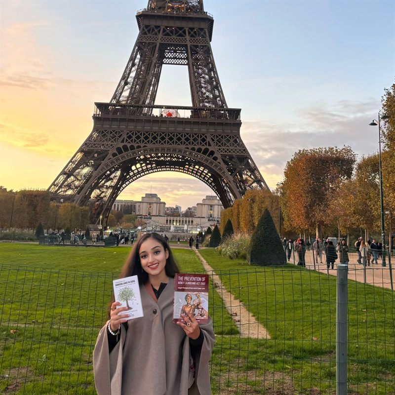 Dr. Jasdeep Kaur holding the two legal publications she has written.